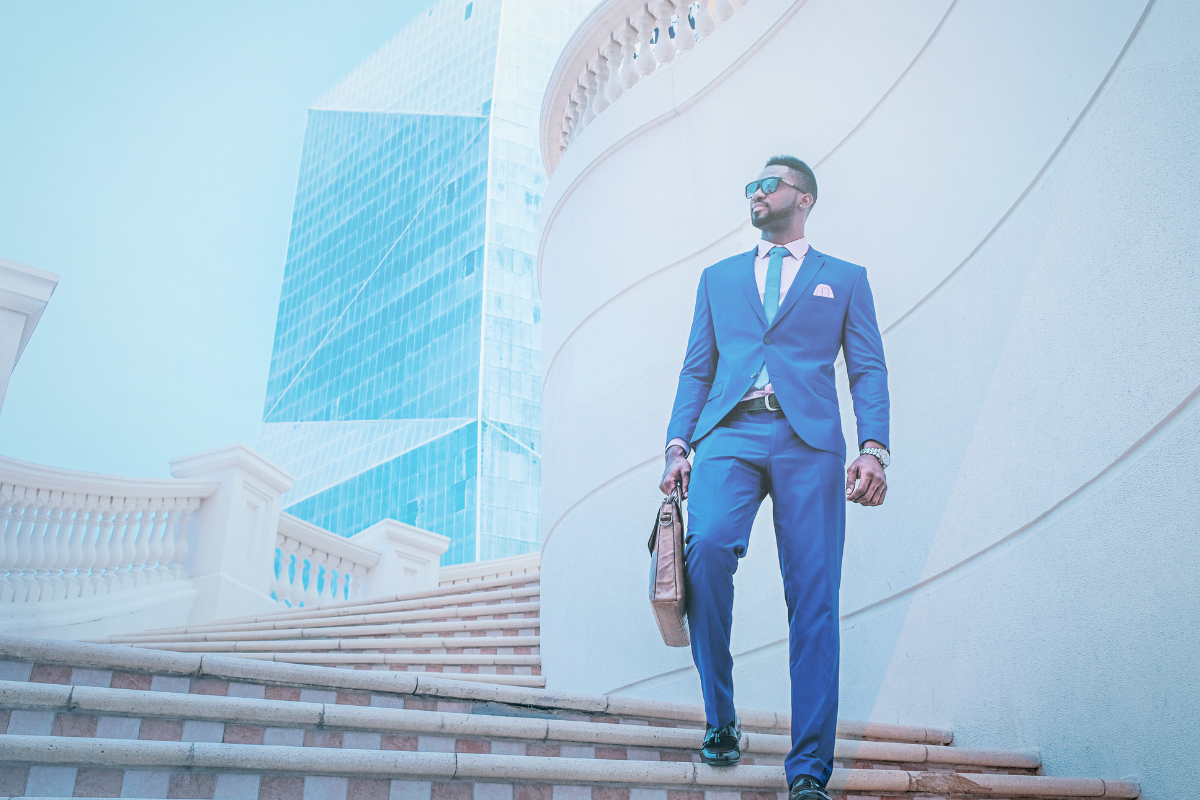 A business person with a breifcase walks down a set of outdoor stairs