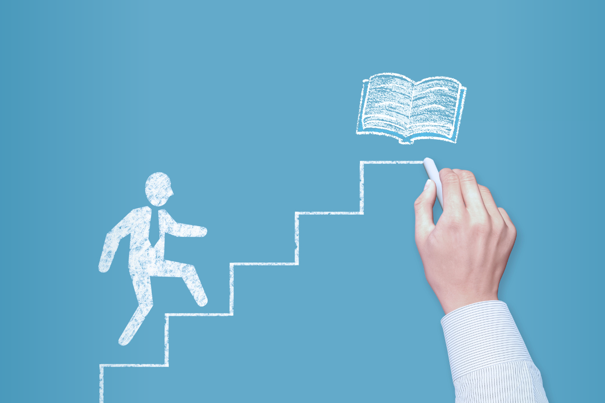 A chalk drawing of a person climbs stairs toward a book