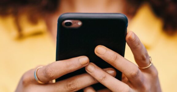 A person smiling at their phone